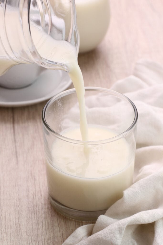dairy free plant milk being poured into a clear glass