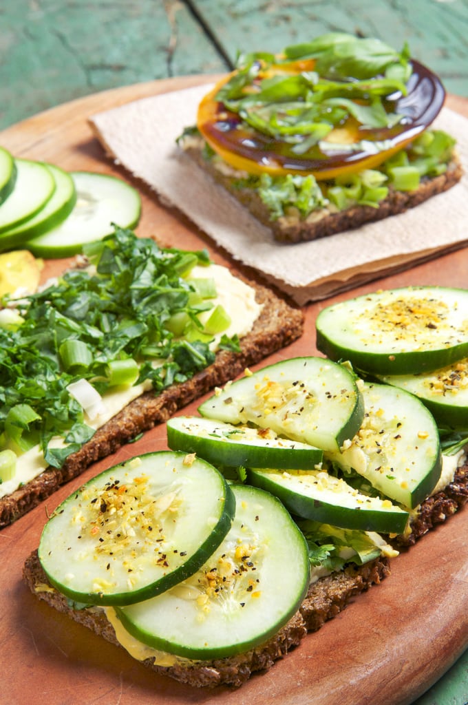 cucumber sandwich open faced on cutting board on grain bread