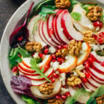 white bowl filled with healthy Waldorf Salad on dark background