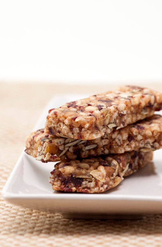 healthy granola bars stacked 3 high on white plate