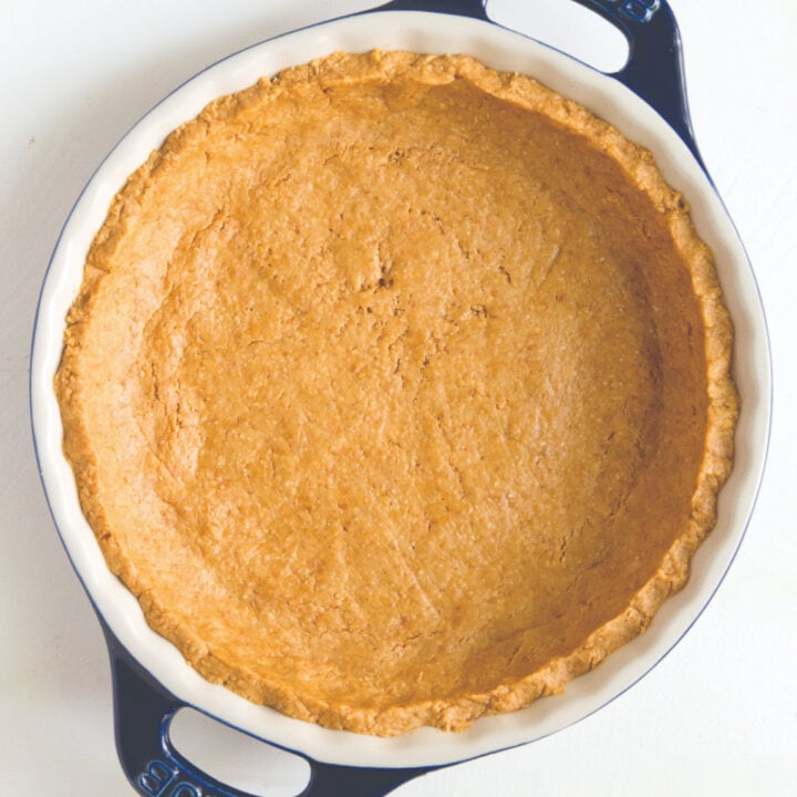 overhead photo of graham cracker crust in white and blue pie pan