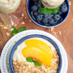 overhead shot of blue bowl filled with vegan yogurt and topped with granola and fruit