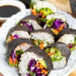 white oval plate with veggie sushi lined up on plate