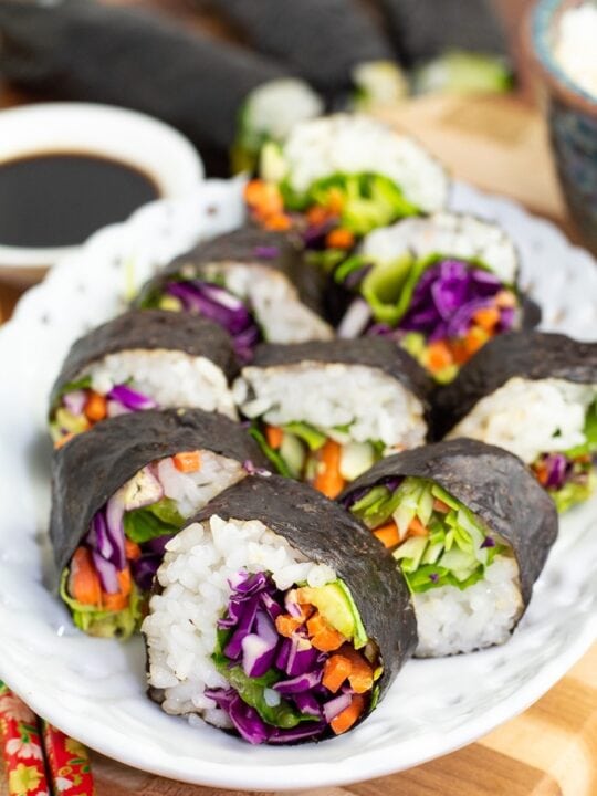 white oval plate with veggie sushi lined up on plate