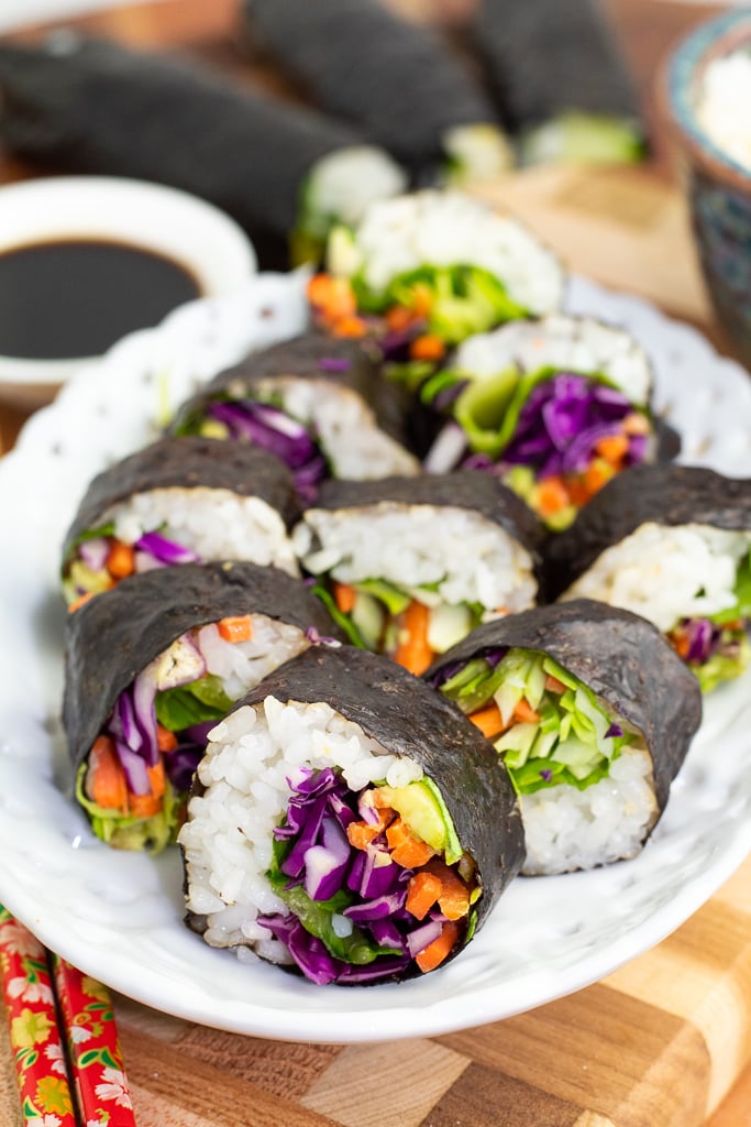 white oval plate with veggie sushi lined up on plate