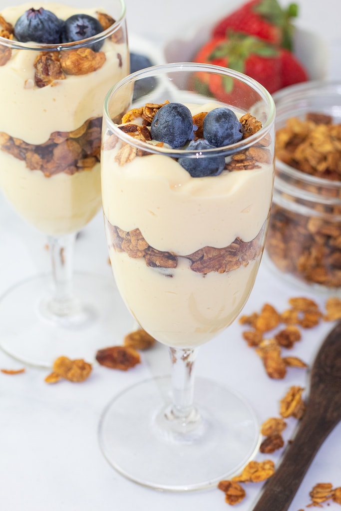 decorative glasses with stems filled with vegan yogurt and gluten free granola