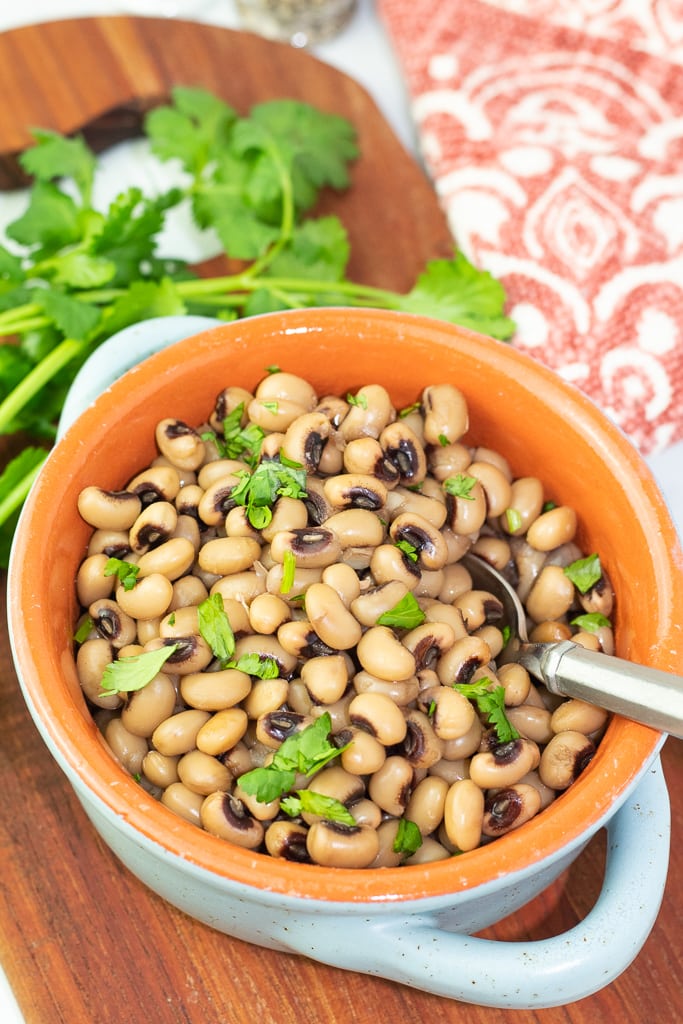 bowl filled with cooked black eyed peas from instant pot and silver spoon