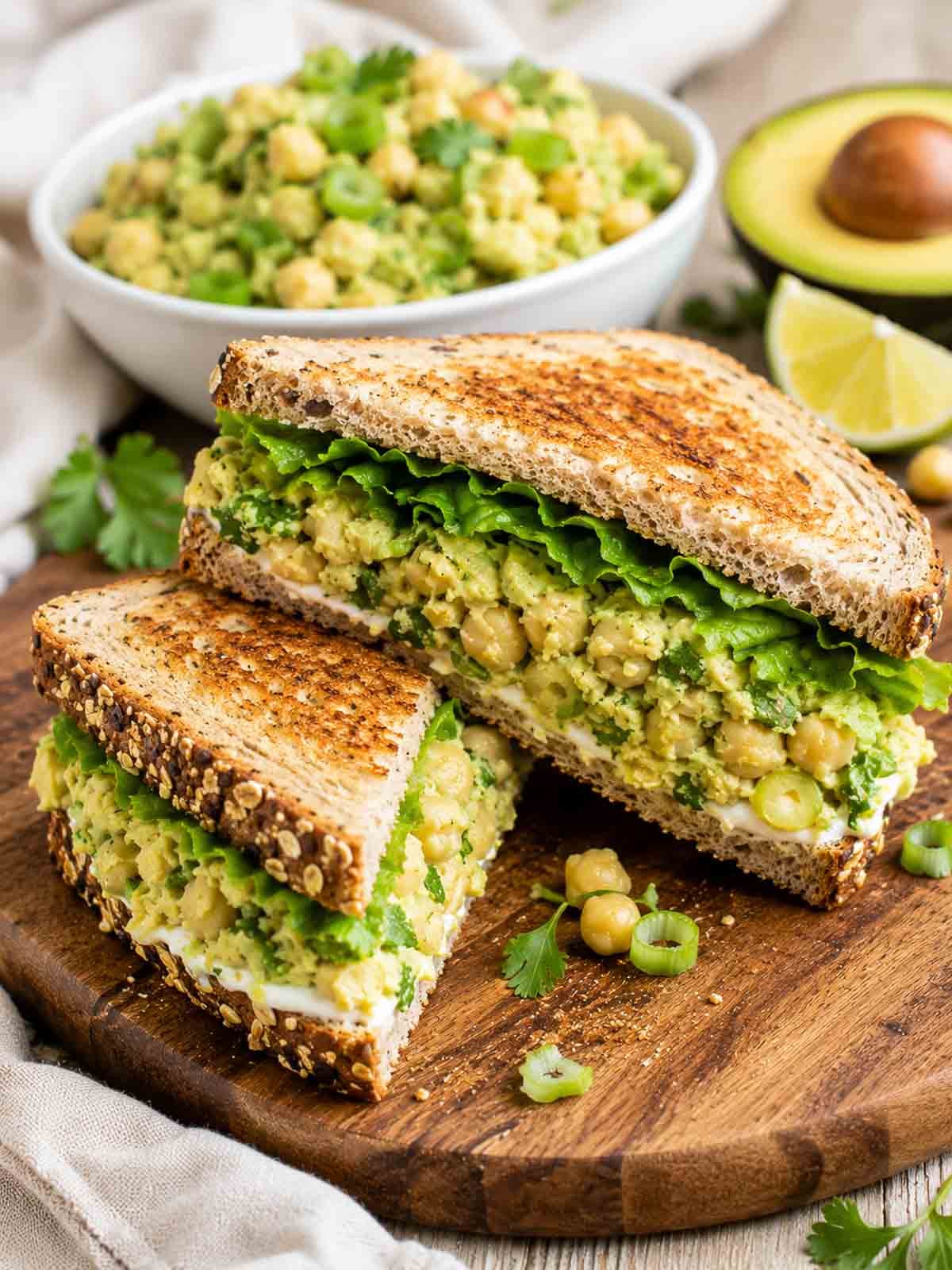chickpea avocado sandwich sliced in half and stacked.