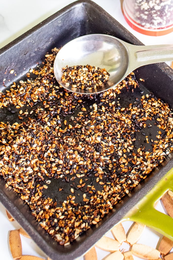 homemade furikake being cooked in black skillet with spoon