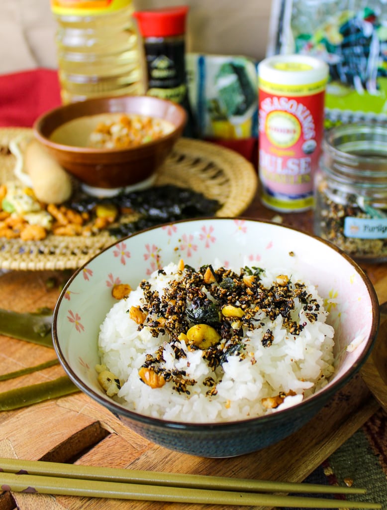 brown floral Japanese rice bowl filled with white rice and homemade furikake on wooden table with ingredients in background