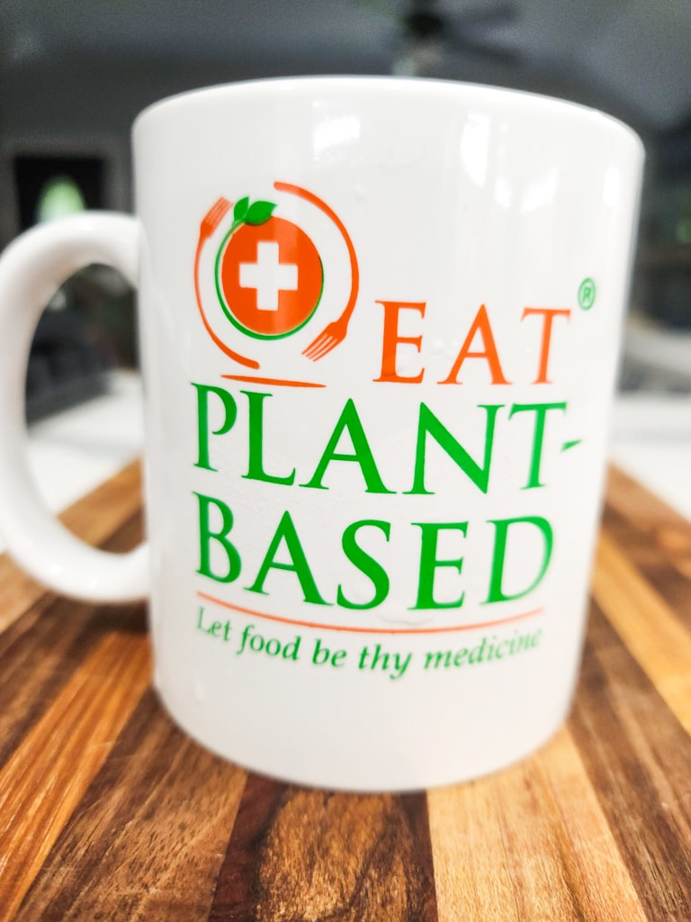 white coffee mug with eatplantbased logo and let food be thy medicine
