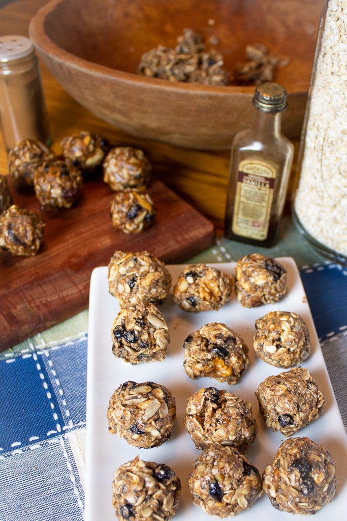 overhead photo of oatmeal power balls with old vanilla botto and ingredients in background
