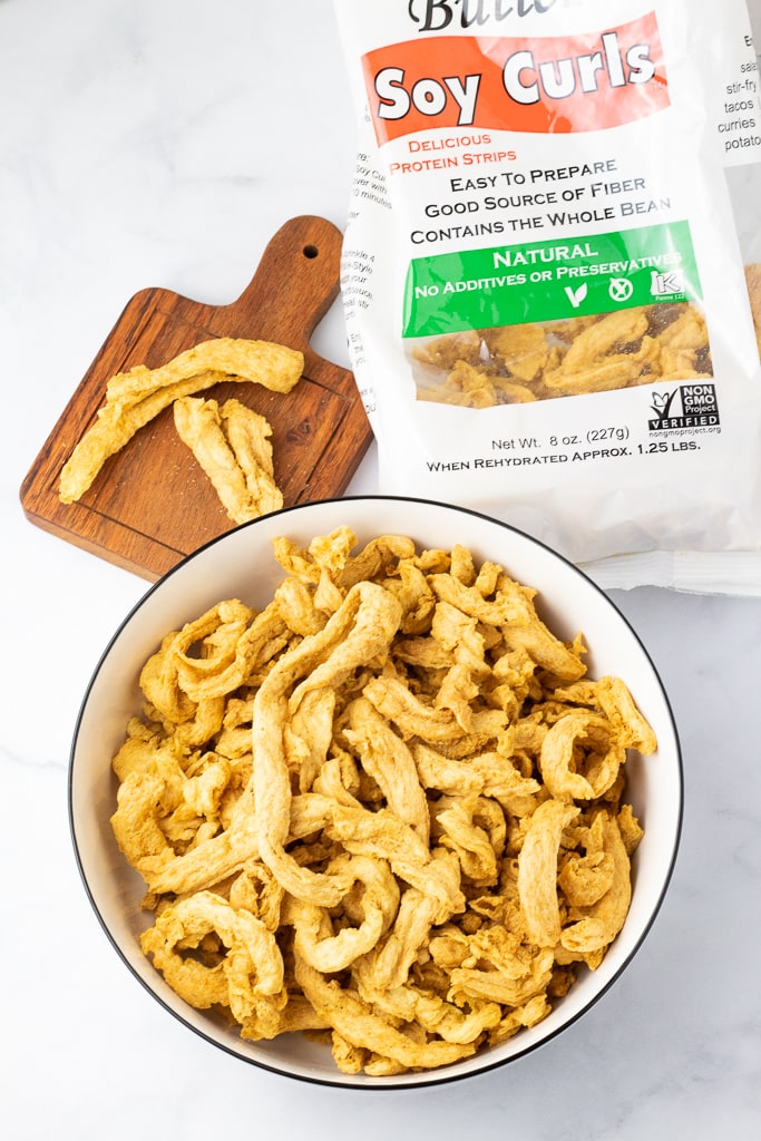 soy curls dried on countertop in bowl with bag beside them