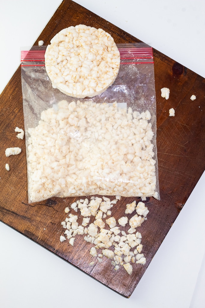 crushed rice cakes in ziplock bag on wooden board