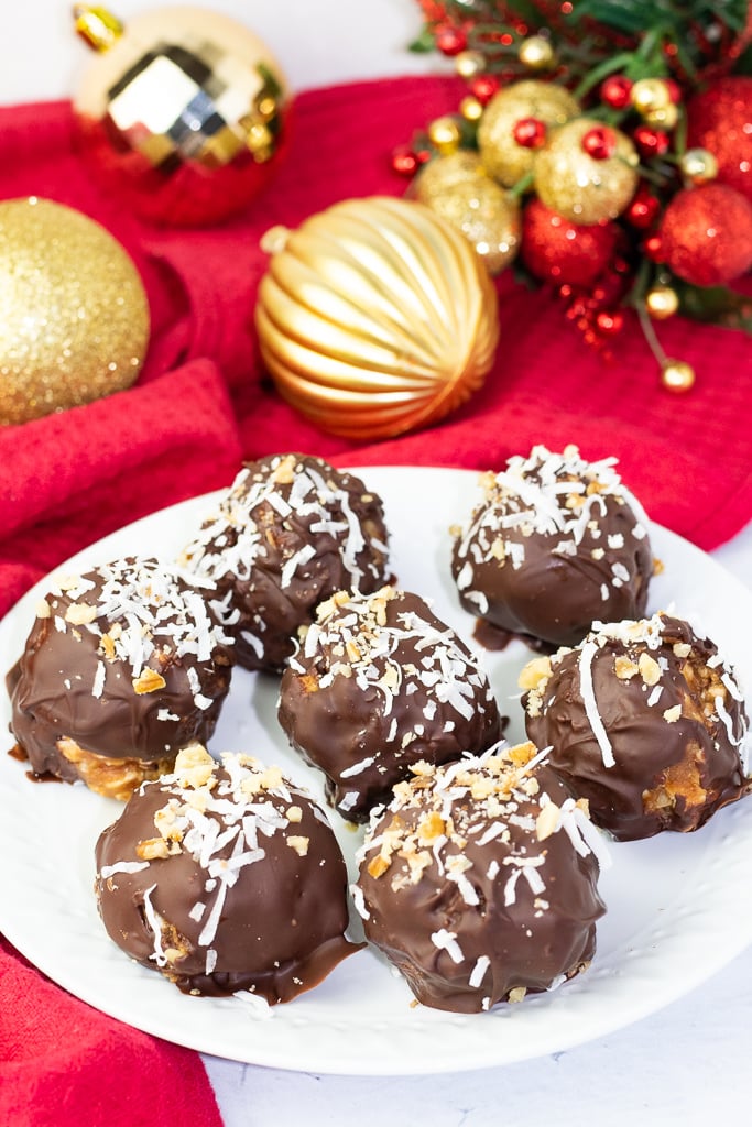 chocolate balls on white plate with red cloth and Christmas ball decorations