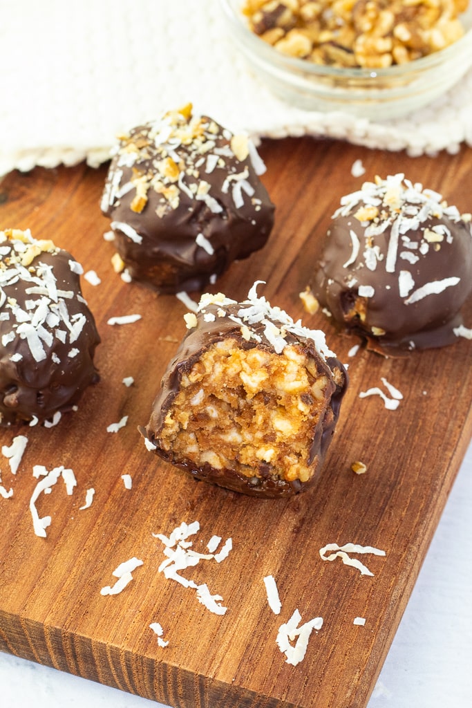 chocolate balls on cutting board with one bite missing