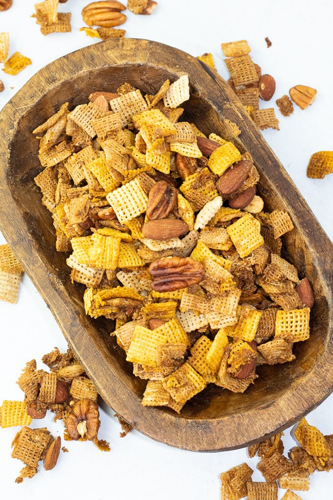 wooden oval handmade bowl filled with homemade chex mix