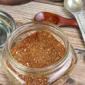 small glass spice jar filled with homemade taco seasoning mix