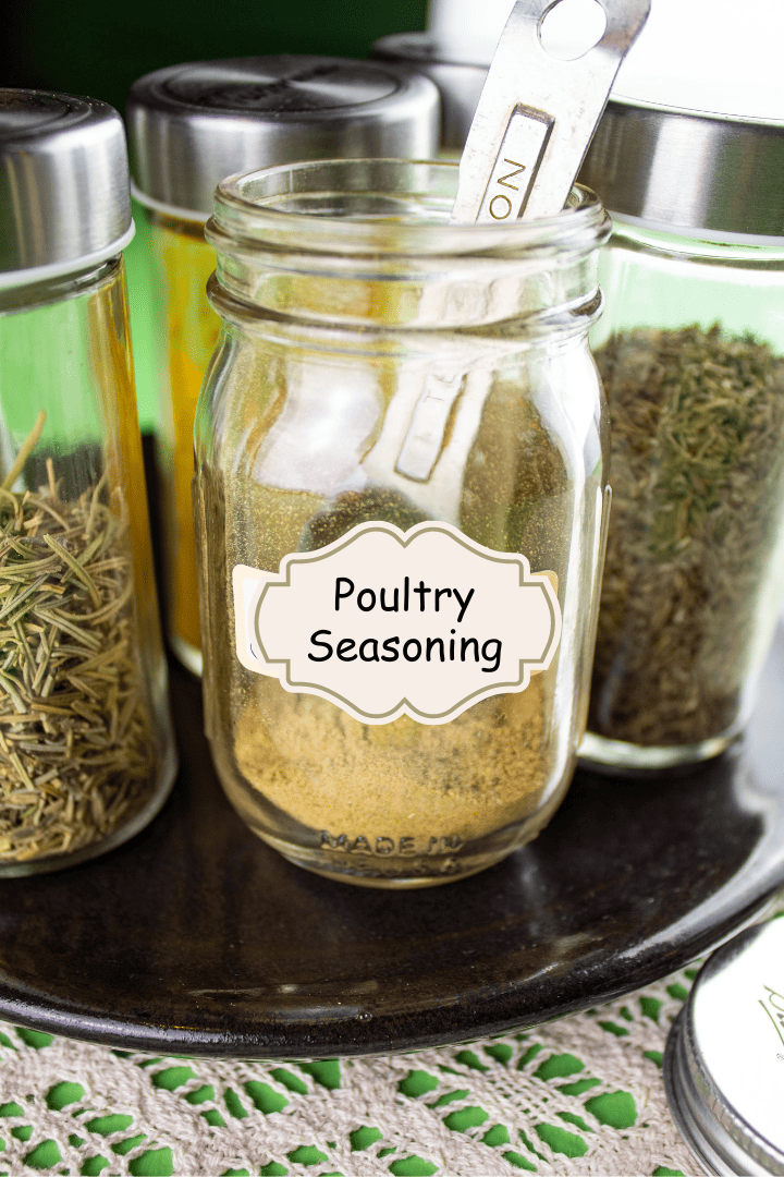 Spice jar with homemade poultry seasoning with measuring spoon inside jar