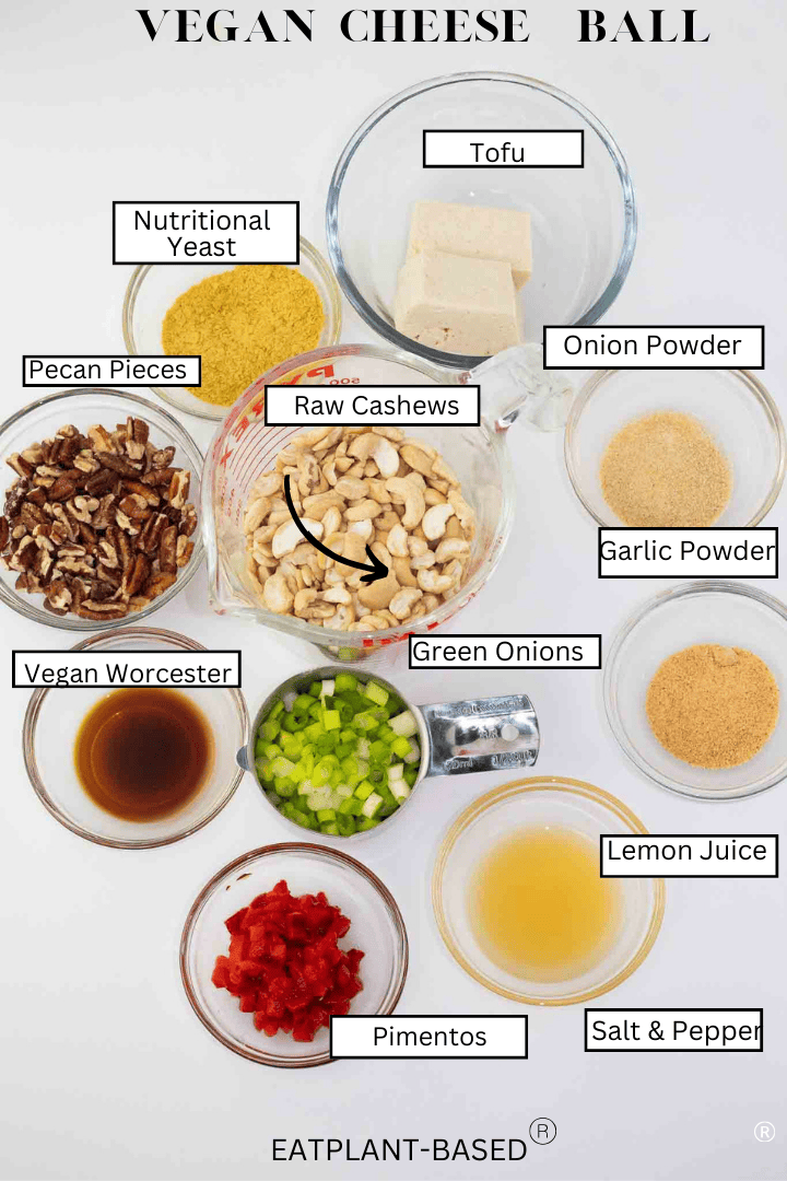 ingredients for vegan cheese ball on white counter-cashews, tofu, pecans, green onions, and seasonings labled on white background.