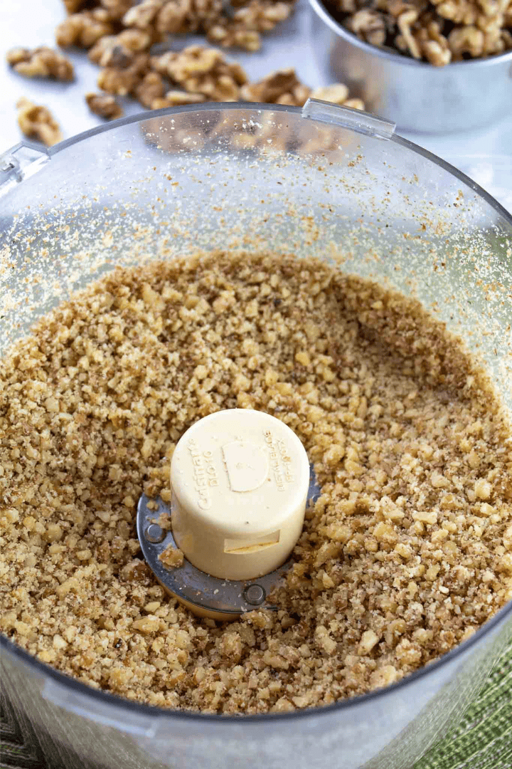 food processor filled with walnuts after grinding.