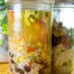 mason jar full of healthy soup with rice and beans.
