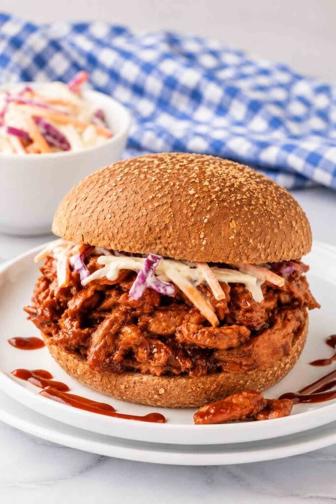 soy curl bbq on a whole-grain bun topped with coleslaw.