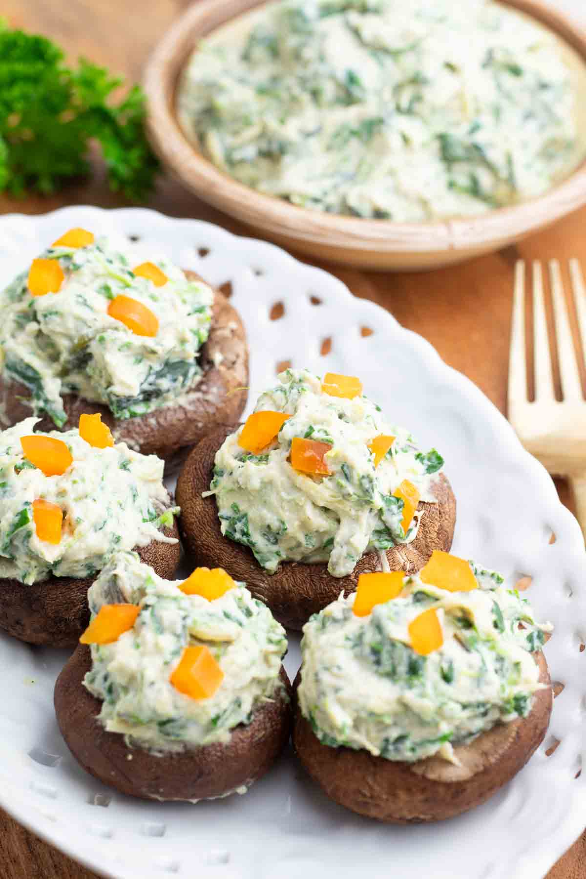 white fancy platter with stuffed vegan mushrooms.