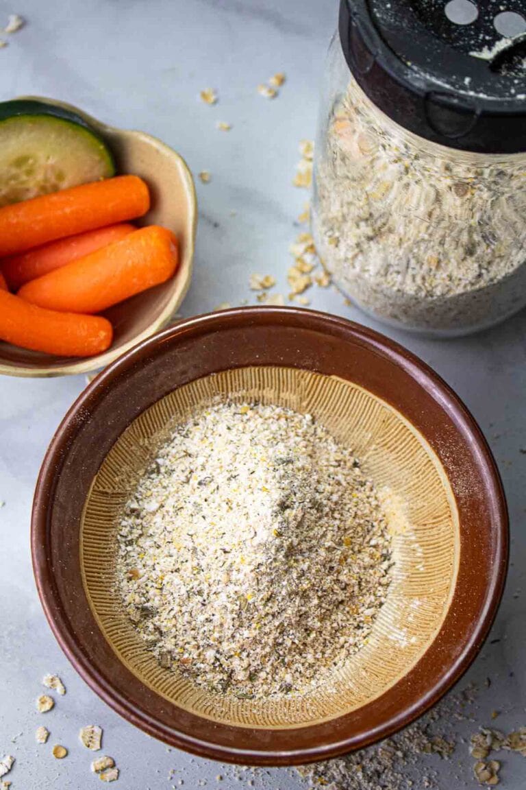 vegan homemade ranch seasoning in a brown bowl with a jar of it beside.