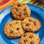 vegan gluten-free chocolate chip cookies on a blue plate on a table.