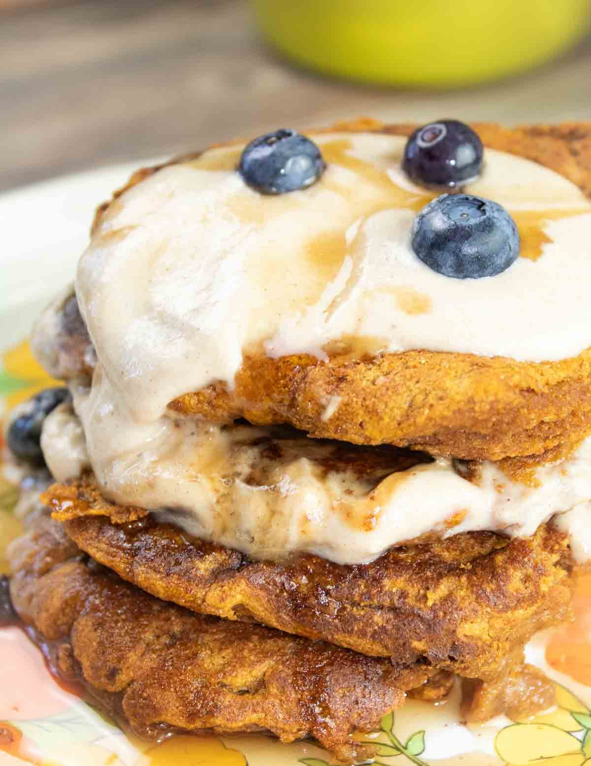 flower plate with 3 pumpkin pancakes on it.