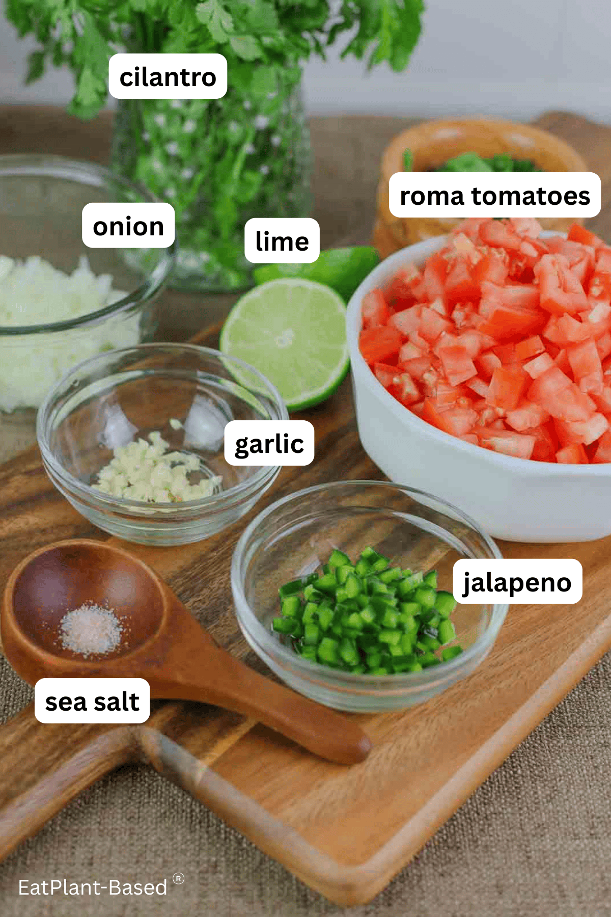 labeled ingredients for pico de gallo on a cutting board.
