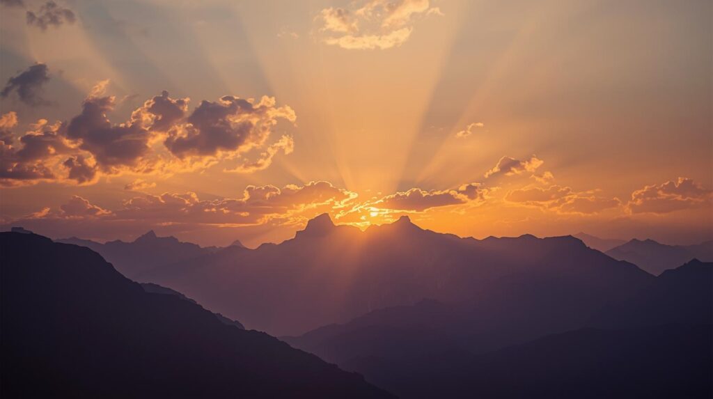 beautiful sunrise over the mountains. light breaking through the clouds.