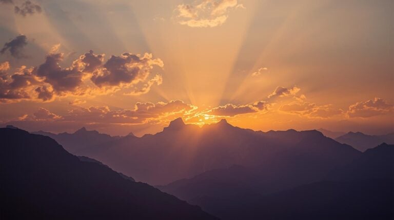beautiful sunrise over the mountains. light breaking through the clouds.