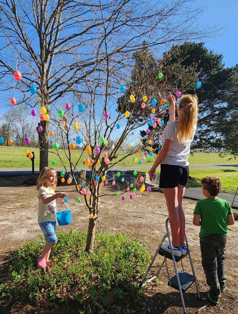 grandkids decorating Grandma Edwards' Easter egg tree with plastic colorful eggs.