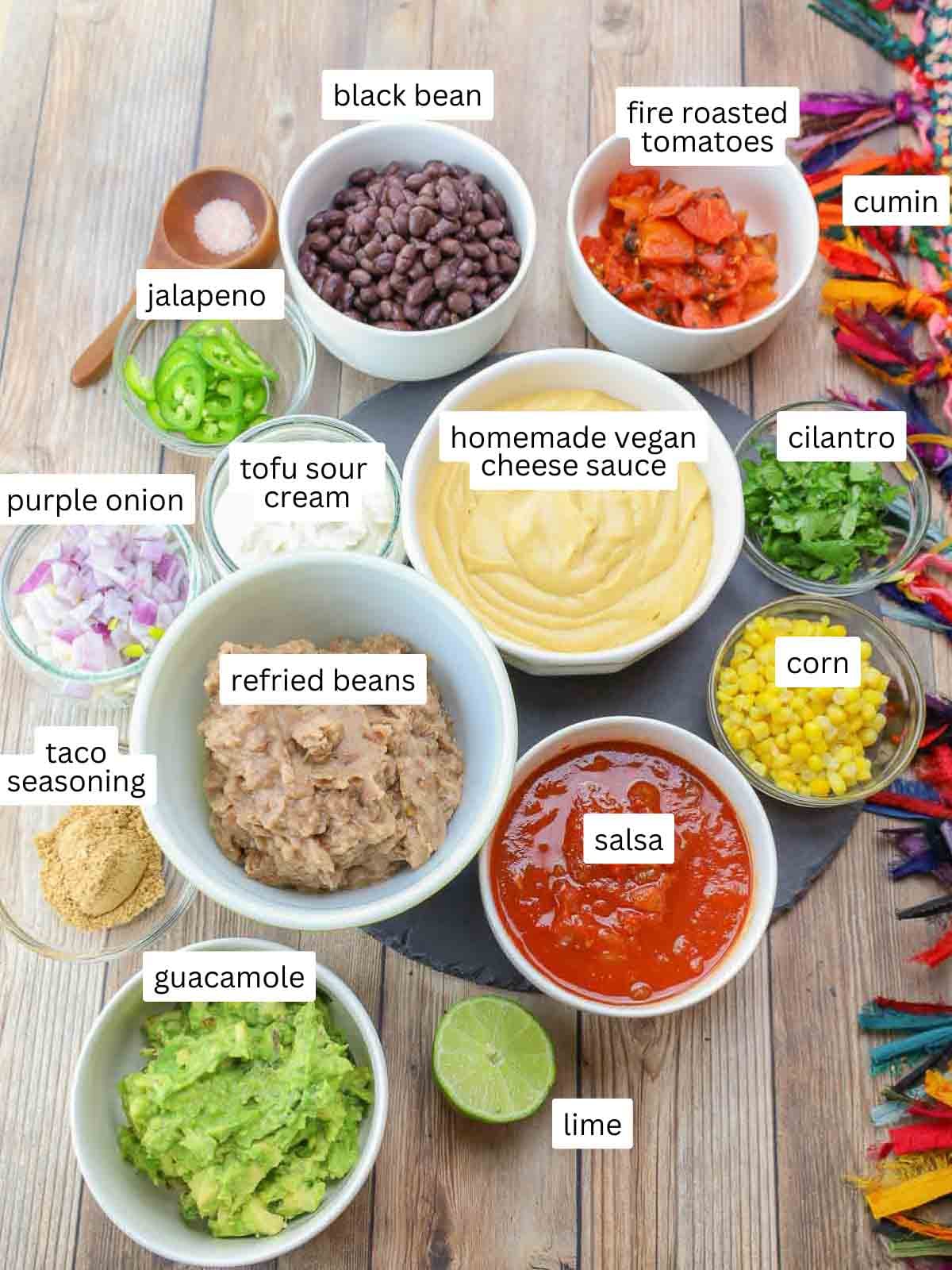 ingredients for 7-layer dip ingredients in bowls and labeled.