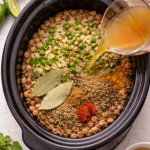 crock pot with dry pinto beans, broth, and seasonings.