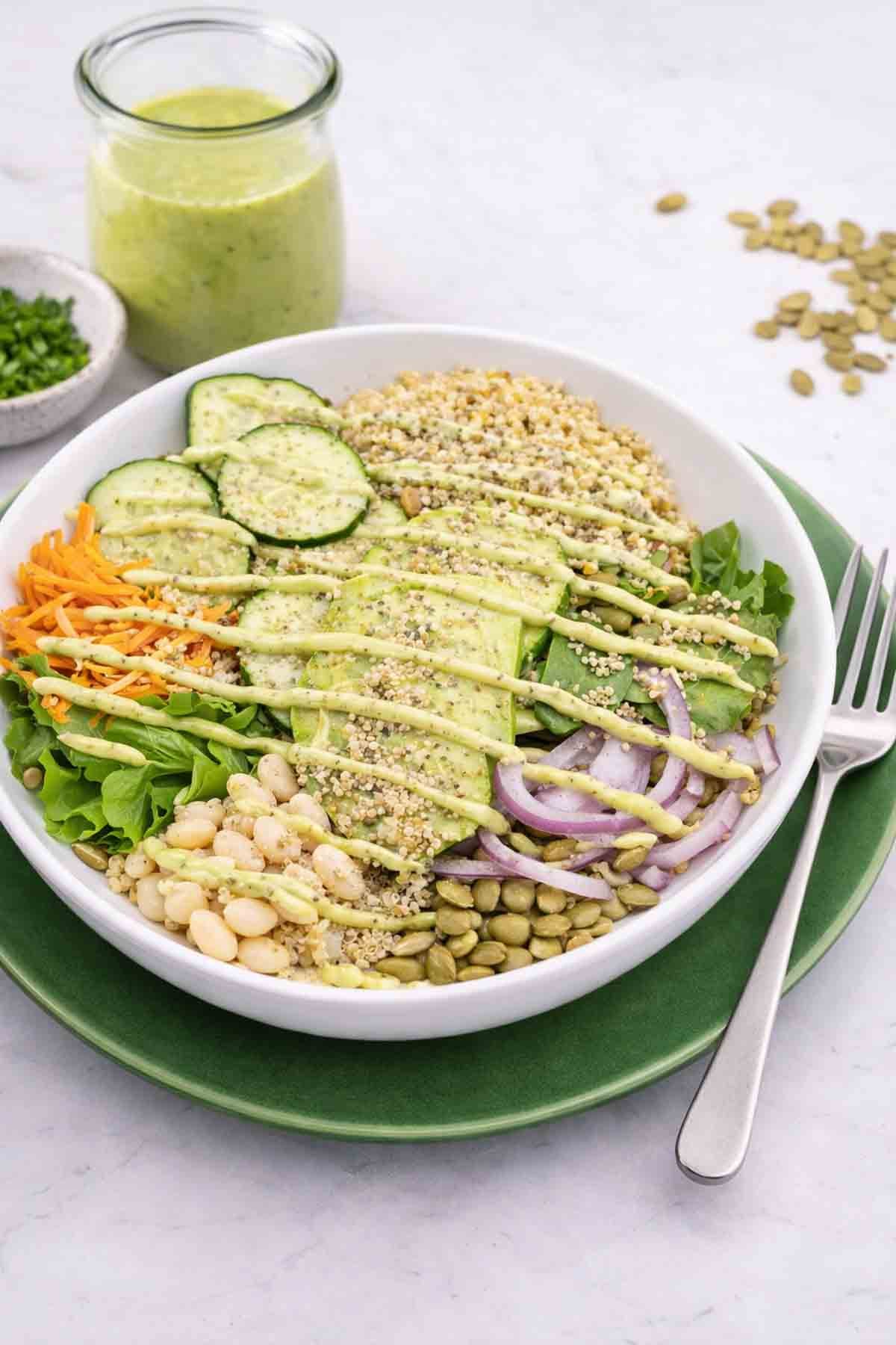 veggie bowl with high protein ingredients like quinoa, beans, spinach, pumpkin seeds.