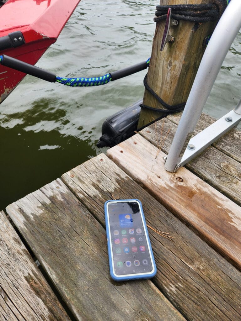 wet cell phone on a boat dock.