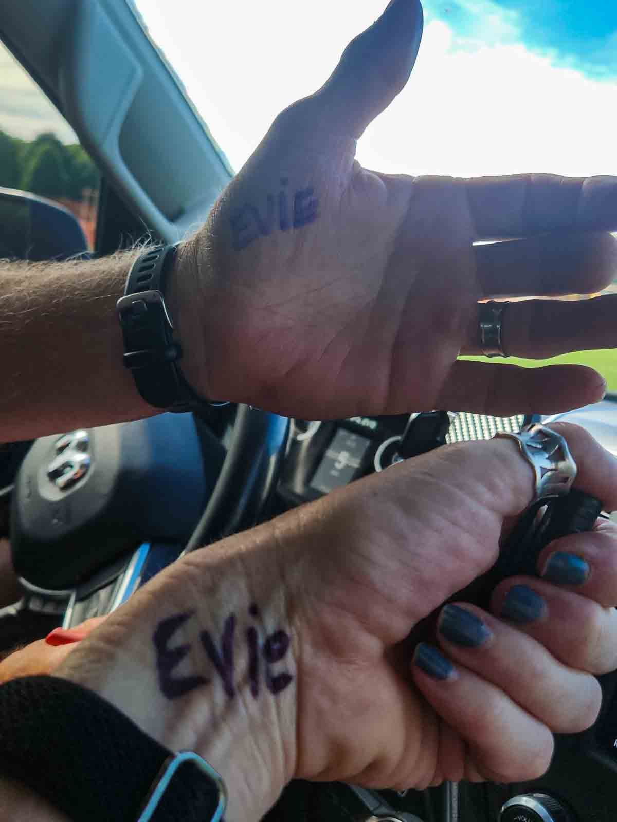 man and woman's arms with EVIE written on them.
