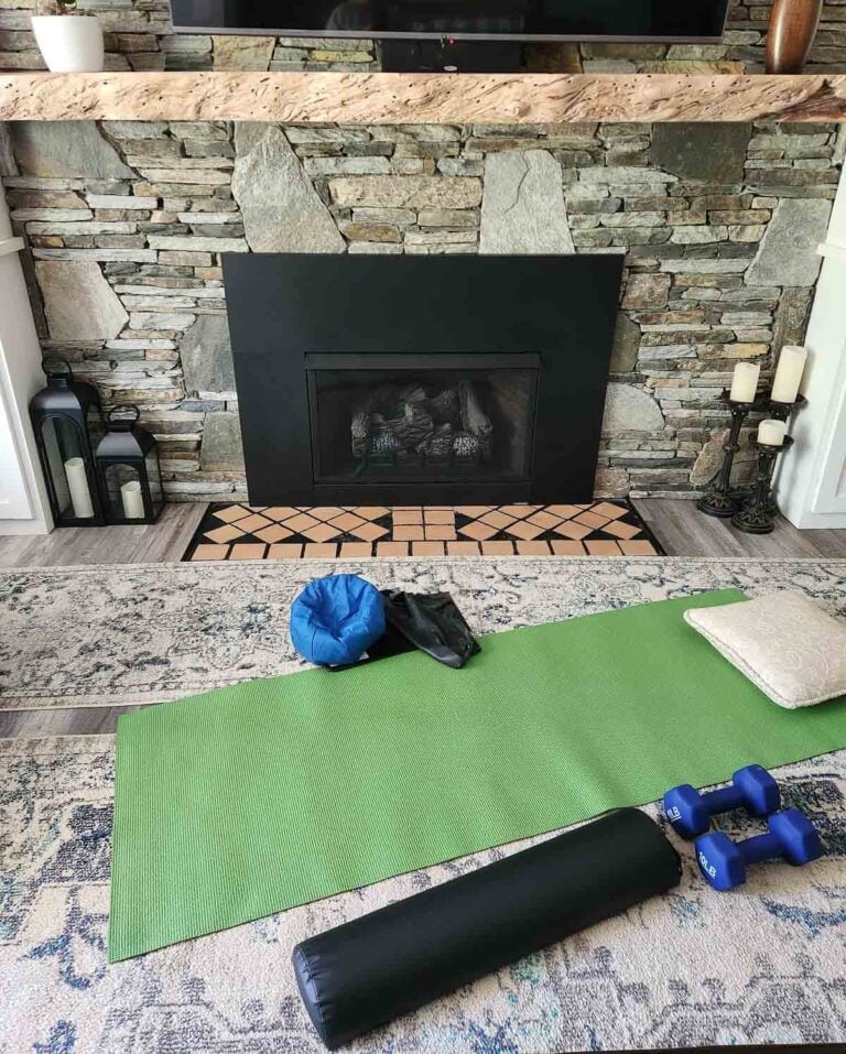 stone fireplace with yoga mat on floor.
