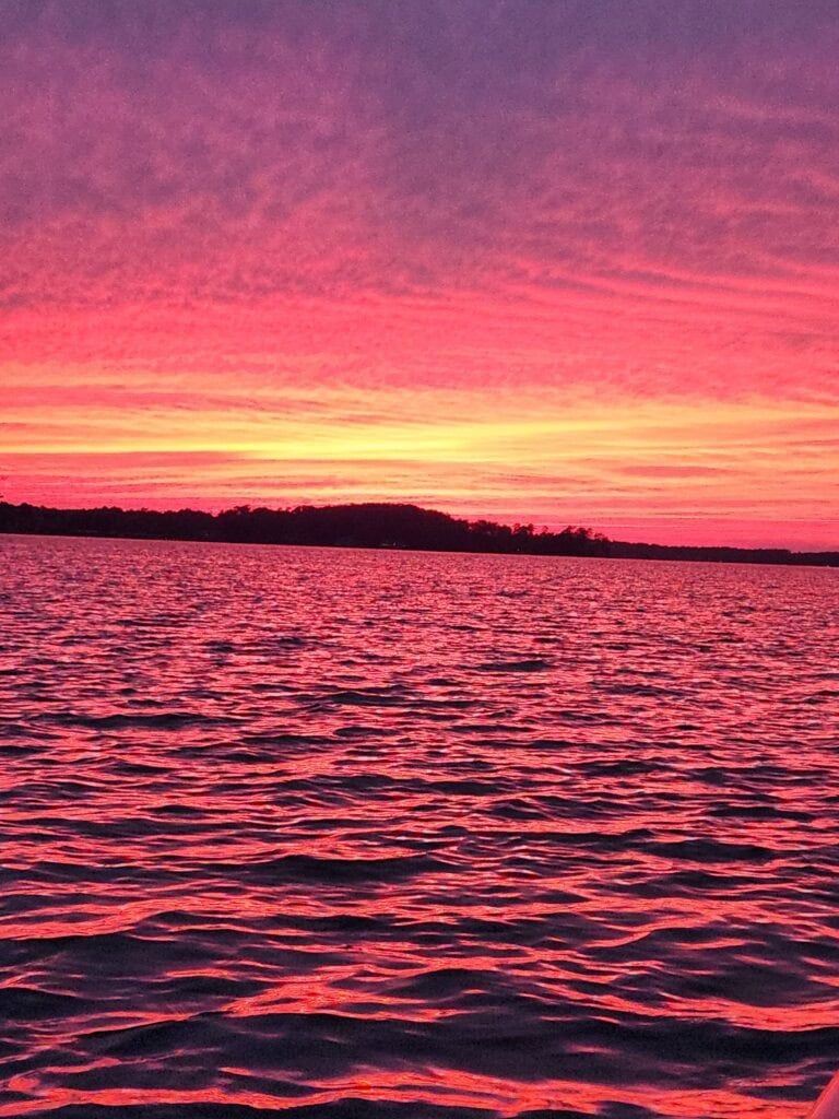 red and yellow sunset over a lake.