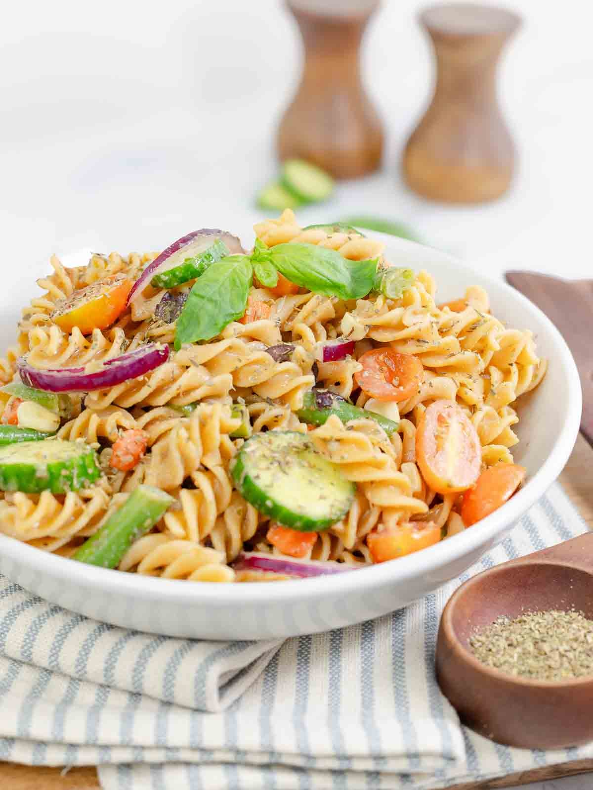 close up of vegetable pasta salad in white bowl.