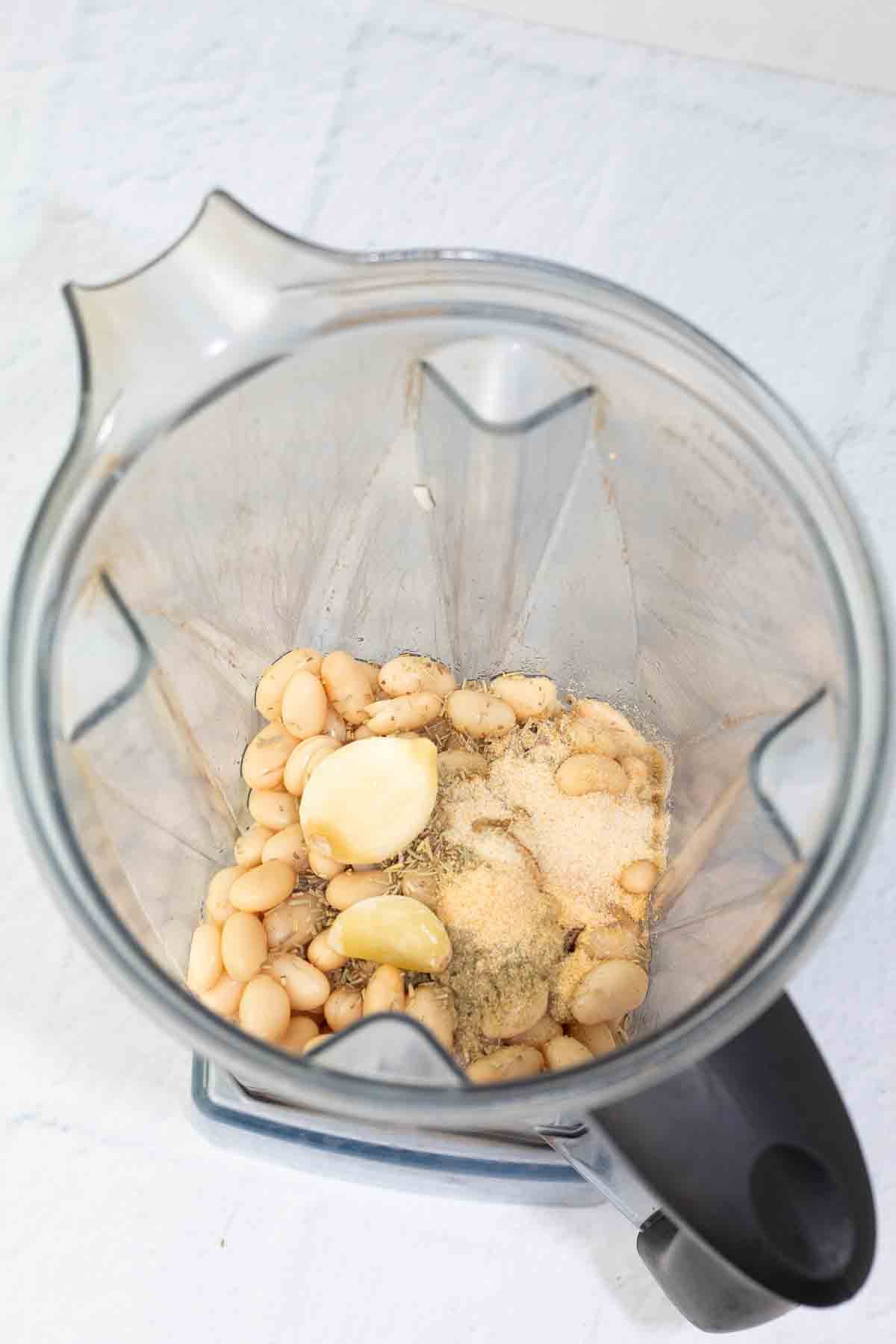 blender with white bean dip ingredients before blending.