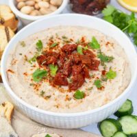 white bean dip with sundried tomatoes in a bowl.