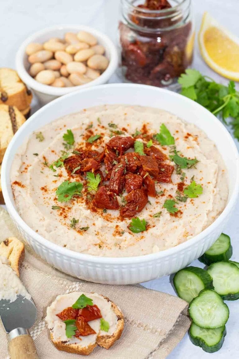 white bean dip with sundried tomatoes in a bowl.