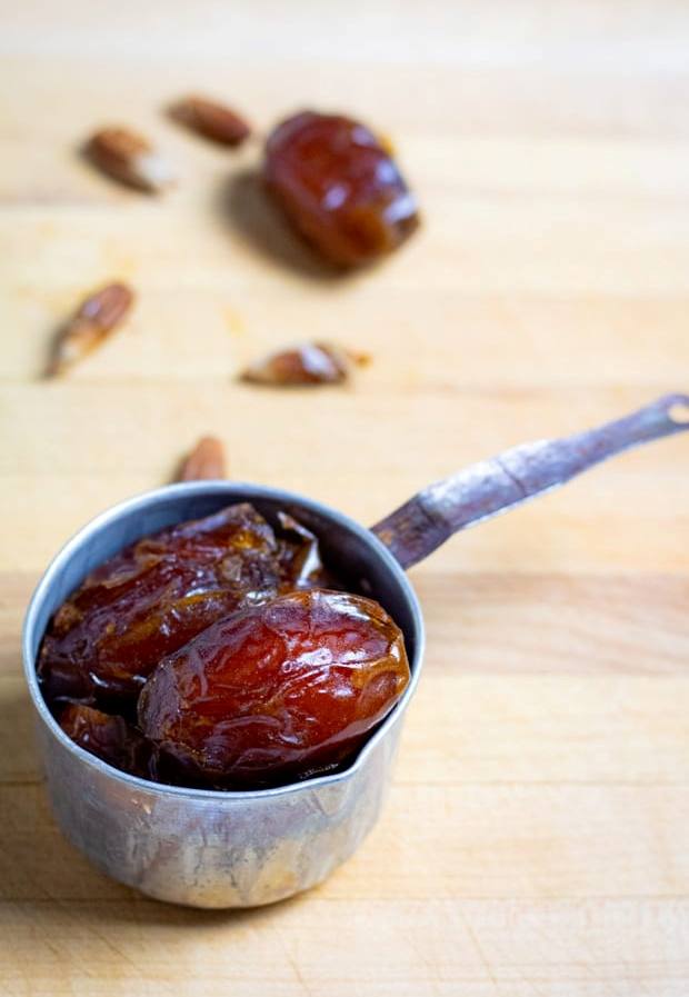 mejool dates in a measuring cup.