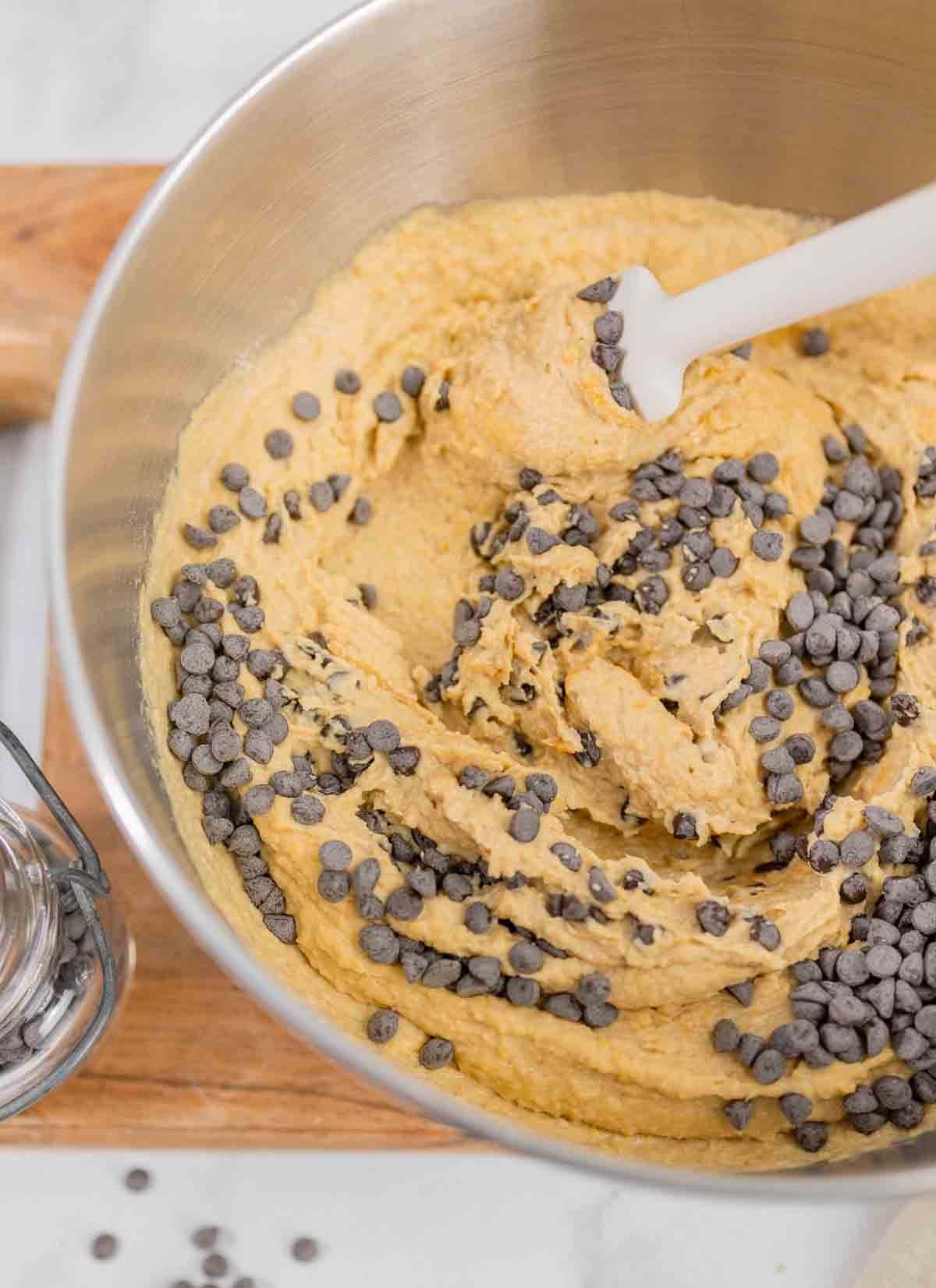 chickpea blondie batter in a mixing bowl with chocolate chips.