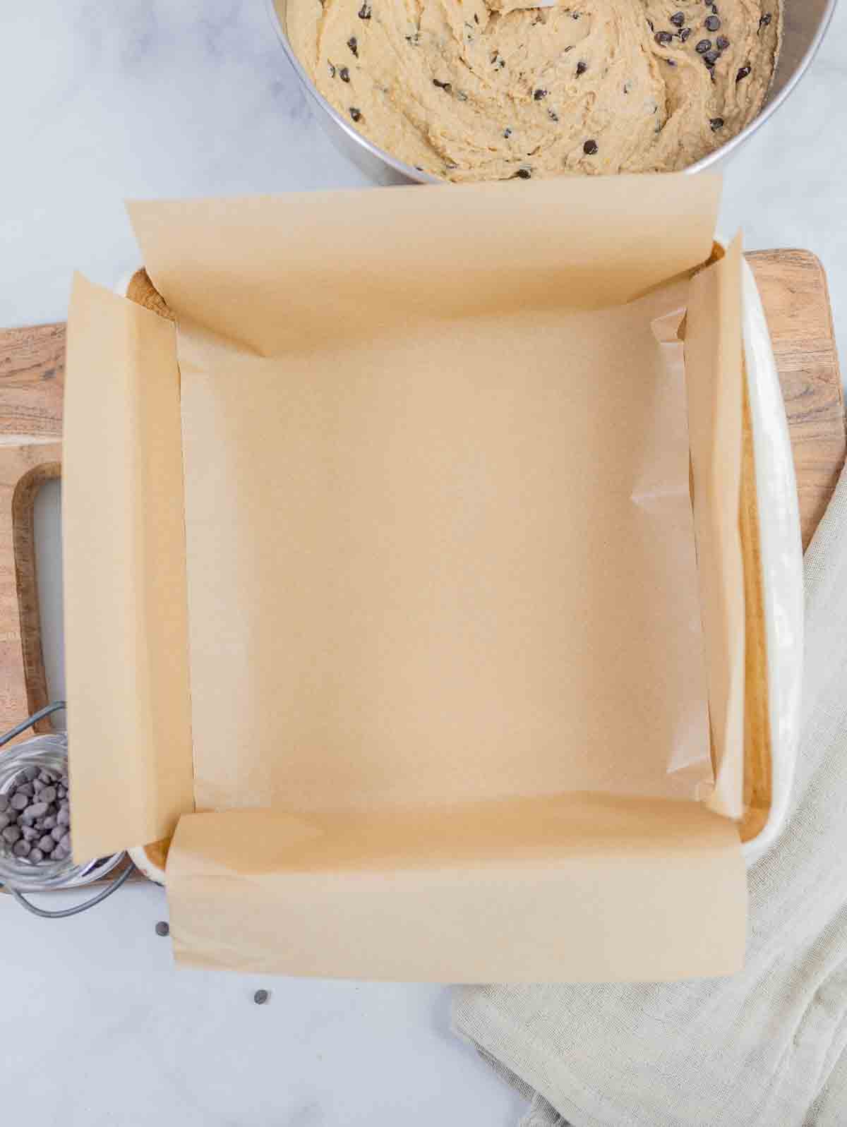 8 x 8 baking dish liked with parchment paper for chickpea blondies.