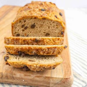 a loaf of cinnamon raisin bread with part of the loaf sliced.